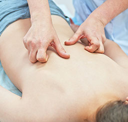 hands massaging somebody's back skin
